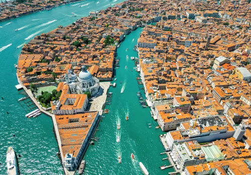 aerial-drone-view-venice-italy-water-channels-with-multiple-floating-moored-boats copia